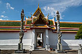 Bangkok Wat Arun - The second entrace gate of the ubosot guarded by two stone pillars with entwined dragons. 